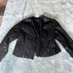 Black leather jacket, metal detailing, shorter in the back